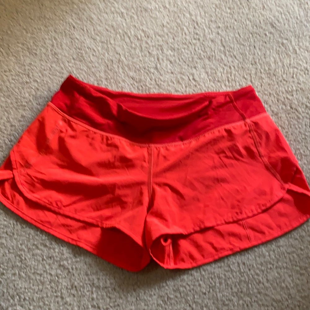 Coral orange lululemon speed shorts.